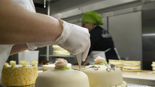 Baker decorating a cake