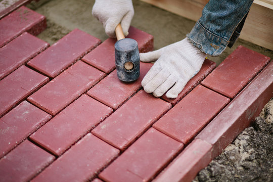 Men Paving Path Using Clinker Brick