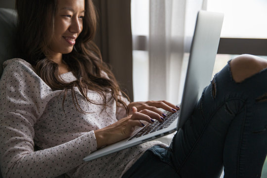Woman working on her laptop from home