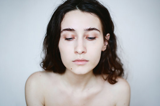Melancholy portrait of young woman with minimum make up