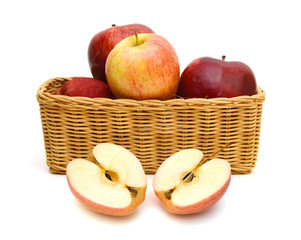 Red apples in the basket on white