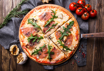 Tasty Italian pizza on a dark wooden background top view