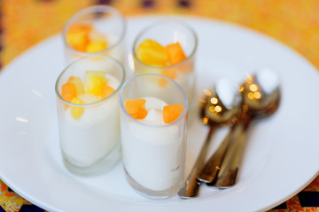 four delicious white dessert souffle with orange fruits