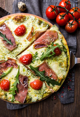 Tasty Italian pizza on a dark wooden background top view