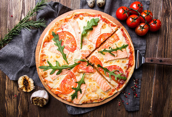 Tasty Italian pizza on a dark wooden background top view