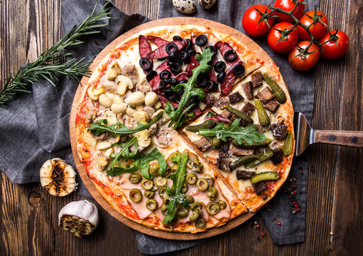 Tasty Italian pizza on a dark wooden background top view