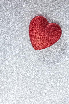 Sparkly red heart against white background
