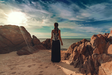 woman silhouette on the beach at sunset