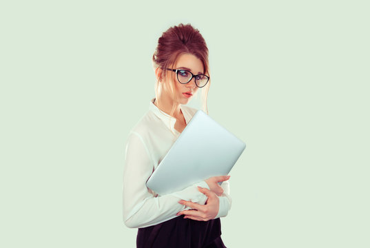 Serious Student with laptop. Closeup woman nerd girl holding books laptop computer slight smile on face, white shirt formal wear, eye glasses, retro hairstyle light green office wall on background
