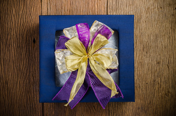 blue gift box on wooden board