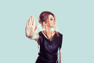 Stop, no. Closeup portrait young annoyed angry woman giving talk to hand gesture with palm outward...