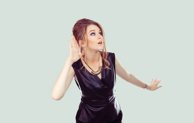 Nosy. Closeup portrait surprised young woman hand to ear gesture carefully intently secretly...