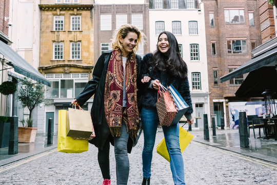 Young Female Best Friends Doing Shopping  on the Streets.