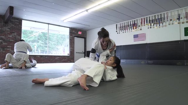 Four people practicing Jiu-jitsu