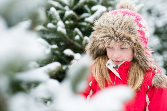 Little Girl in Winter Snowy Christmas Tree Farm
