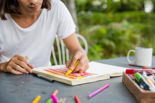 Young Artist Drawing In His Notebook