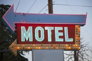 vintage retro neon motel sign lit at dusk