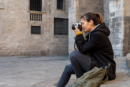Young woman shooting on camera