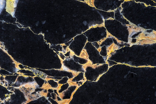 detail of cracking of texture on golden black marble pattern