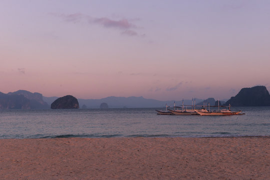 Typical philippines bankas on sea water at sunset
