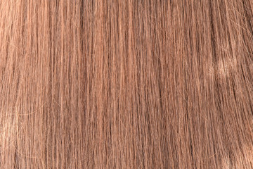 Natural colored shiny healthy human hair. Haircare technology, style and beauty concept. Abstract texture background. Detailed closeup