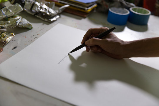 An artist making a sketch on a piece of paper