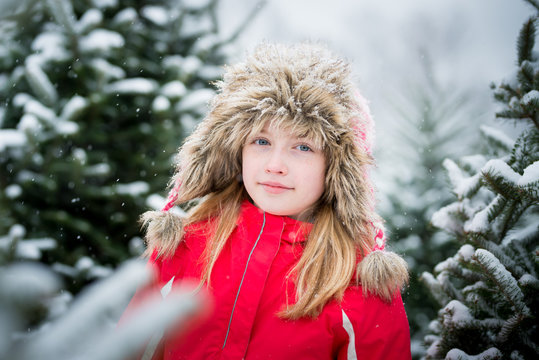 Little Girl in Winter Snowy Christmas Tree Farm