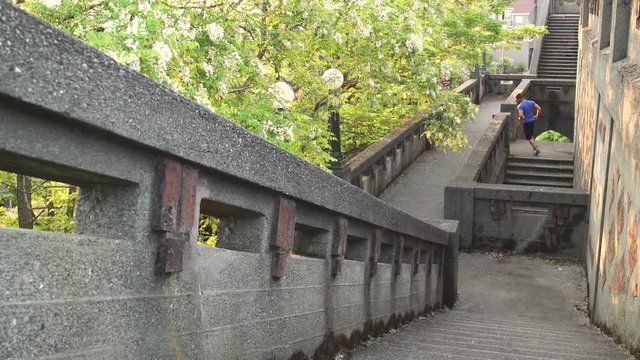 Wide shot of man running up stairs