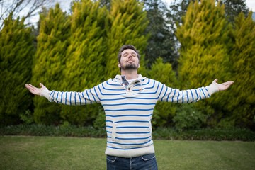 Man standing with arms wide open