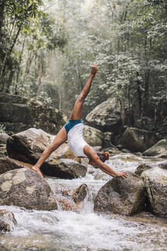 Woman Doing Yoga on the Rocks