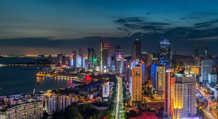 City by river illuminated at night