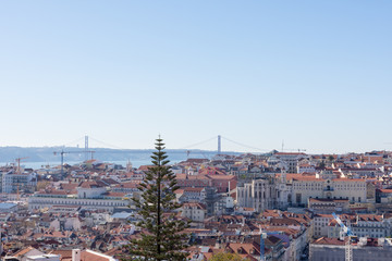 Obraz premium Cidade Baixa, Tejo River and 25 de Abril Bridge, in the city of Lisbon, Portugal.