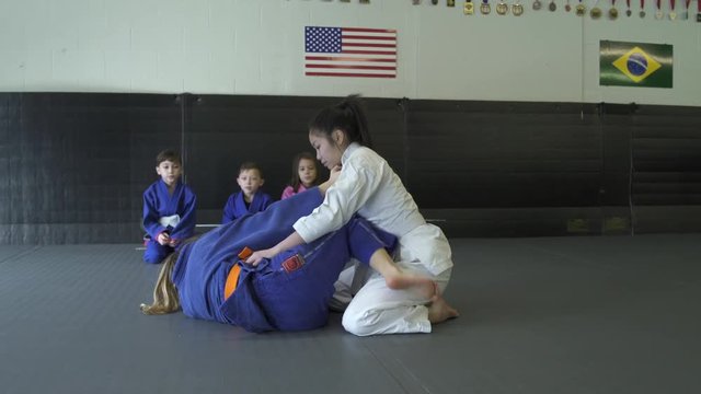 Teenage girls showing Jiu-jitsu moves for children