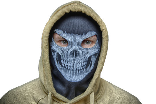 Man In Balaclava Skull Mask And Hood, Maybe Halloween Costume (robber, Burlgar, Snatcher, Terrorist Or Evil Anonymous) With White Back. Isolated Image