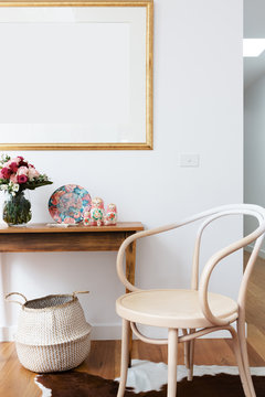 Interior decoration styled with chair and side table and blank wall frame