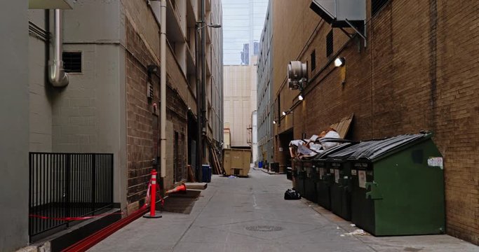 A daytime overcast static background plate of an alley in a large city's downtown district. Day/night matching available.  	