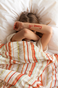Tween girl with 'go away' message on her arm