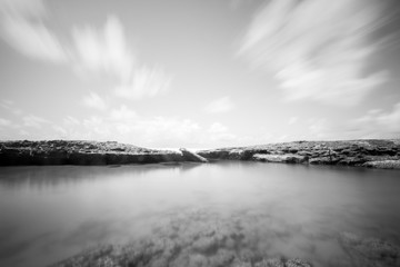 Long exposure photo of beach with rocks (black and white)