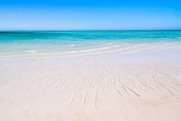 Fototapeta na wymiar Clear waters and white sand beach