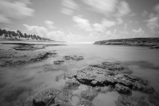 Long exposure photo of beach with rocks (black and white)