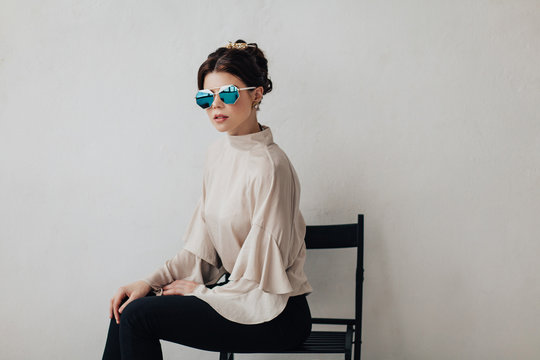 Elegant woman on chair in studio