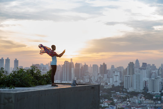 Woman standing at the rooftop