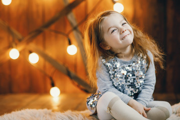 little blonde baby girl sitting on the floor