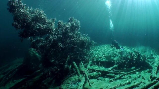 Scuba diving in Fernsteinsee mountain lake underwater Tyrol Austria. Beautiful emerald green alpine attractions of nature of Fernpass in Nassereith.