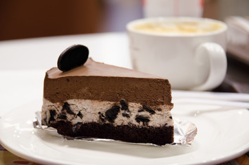 Chocolate Cheesecake on the white plate with coffee cup background