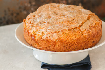 Irish apple pie on a white plate with vanilla custard sauce. Festive dessert for St.Patricks Day.
