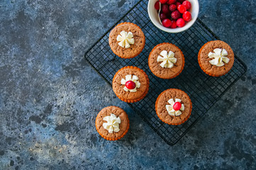 Brownie mins pies served on a wire rack on a blue stone background.