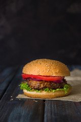 Fast food, homemade burger on a wooden background