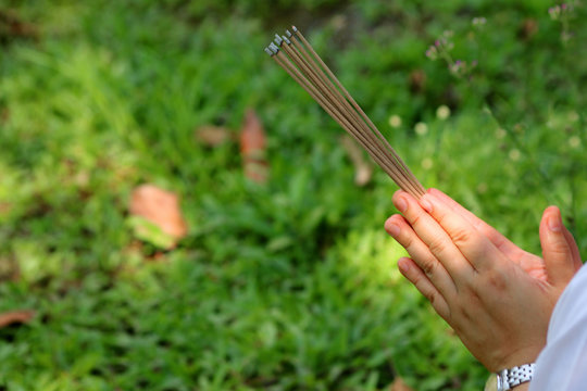 Asian people with incense pay respect to shrine or spirit worship