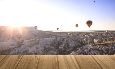 Wood top table on top View air balloons landing in a mountain Cappadocia Turkey